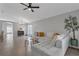 Spacious living area featuring a modern white sofa and stylish decorations at 2849 Doe Run Trl, Orange City, FL 32763