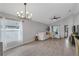 Bright living room with tile floors, large windows, and modern chandelier at 2849 Doe Run Trl, Orange City, FL 32763