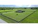 Aerial view of the property highlighting its vast green land and perimeter fence at 29222 Can Do Ln, Tavares, FL 32778