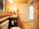 Well-lit bathroom showcasing granite countertops and an inviting open door to the outdoor lanai at 29222 Can Do Ln, Tavares, FL 32778