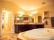 Bathroom with soaking tub, dual sinks and large mirror at 29222 Can Do Ln, Tavares, FL 32778