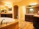 Spacious bathroom with soaking tub, dual vanities, and decorative rug at 29222 Can Do Ln, Tavares, FL 32778
