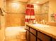 Bathroom featuring bathtub, shower with red curtain, sink and vanity at 29222 Can Do Ln, Tavares, FL 32778