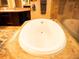 Close-up of soaking tub with tile surround, part of a luxurious bathroom at 29222 Can Do Ln, Tavares, FL 32778
