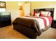 Bedroom with large bed, side table and carpet at 29222 Can Do Ln, Tavares, FL 32778