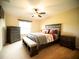 A cozy bedroom with a plush bed, complemented by a dresser and bench, offering comfort and style at 29222 Can Do Ln, Tavares, FL 32778