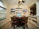 Relaxing dining area features a ceiling fan, a round table, and views of a large TV at 29222 Can Do Ln, Tavares, FL 32778