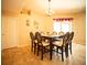 Dining room with a glass-top table, upholstered chairs, and chandelier lighting at 29222 Can Do Ln, Tavares, FL 32778