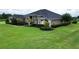 Well-manicured landscaping accentuates the architectural details of this lovely home at 29222 Can Do Ln, Tavares, FL 32778