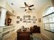 Comfortable home office featuring elegant desk, ceiling fan, and arched window at 29222 Can Do Ln, Tavares, FL 32778
