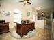 Inviting home office with executive desk, ceiling fan, and natural light from arched windows at 29222 Can Do Ln, Tavares, FL 32778