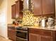 Modern kitchen featuring granite countertops, stainless steel appliances, and dark wood cabinetry at 29222 Can Do Ln, Tavares, FL 32778