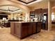 Open-concept kitchen with a large island, stainless steel appliances, and dark wood cabinetry at 29222 Can Do Ln, Tavares, FL 32778