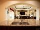 Gourmet kitchen with granite countertop, stainless steel sink, and views of the living room at 29222 Can Do Ln, Tavares, FL 32778