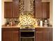 Modern kitchen featuring granite countertops, stainless steel appliances, and dark wood cabinetry at 29222 Can Do Ln, Tavares, FL 32778