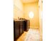 A cozy laundry room is enhanced by cabinets, shelving and natural light from a round window at 29222 Can Do Ln, Tavares, FL 32778