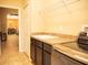 Well-lit laundry room showcases updated appliances, cabinets and adjoins to the dining area at 29222 Can Do Ln, Tavares, FL 32778
