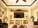 Elegant living room with a ceiling fan, a built-in entertainment center and stylish decor at 29222 Can Do Ln, Tavares, FL 32778