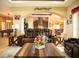 Cozy living room featuring leather seating, stylish decor, and an open view into the kitchen and dining room at 29222 Can Do Ln, Tavares, FL 32778