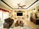 Elegant living room with a ceiling fan, a built-in entertainment center and stylish decor at 29222 Can Do Ln, Tavares, FL 32778