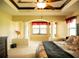 Main bedroom enhanced by carpeting, tray ceilings, decorative columns, and natural light at 29222 Can Do Ln, Tavares, FL 32778