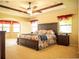 A primary bedroom features a tray ceiling, carpeting, and a decorative column at 29222 Can Do Ln, Tavares, FL 32778