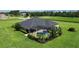 Home featuring a screened-in pool area and beautiful garden in lush backyard at 29222 Can Do Ln, Tavares, FL 32778