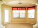 Bright sitting area features decorative columns, three sunlit windows and a glass door at 29222 Can Do Ln, Tavares, FL 32778
