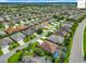 Wide view of a community featuring homes, manicured lawns, palm trees, and streets at 2994 Adrienne Way, The Villages, FL 32163