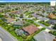 Aerial view of a neighborhood featuring lush landscaping, houses, and community roads at 2994 Adrienne Way, The Villages, FL 32163