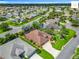 Aerial view showcases this home's prime location with nearby mature landscaping and pristine street at 2994 Adrienne Way, The Villages, FL 32163