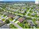Overhead view of a lush community with mature landscaping, picturesque streets and a community lake at 2994 Adrienne Way, The Villages, FL 32163