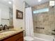 Bathroom featuring tiled shower and granite vanity at 2994 Adrienne Way, The Villages, FL 32163