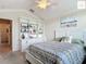 Bedroom with built-in shelving, ceiling fan, and comfortable bed at 2994 Adrienne Way, The Villages, FL 32163