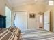 Bedroom featuring a queen-sized bed with striped bedding, a window with blinds, and a closet at 2994 Adrienne Way, The Villages, FL 32163