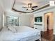 Bedroom with hardwood floors, tray ceiling, ceiling fan, and walk-in closet at 2994 Adrienne Way, The Villages, FL 32163