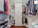 Walk-in closet with built-in shelving, drawers, and hanging rods for clothing storage at 2994 Adrienne Way, The Villages, FL 32163