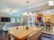 Open-concept dining area provides a seamless transition to the living room and modern kitchen at 2994 Adrienne Way, The Villages, FL 32163