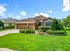 Beautifully maintained home with lush lawn, manicured landscaping, and a three car garage at 2994 Adrienne Way, The Villages, FL 32163
