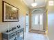 Foyer showcasing tile flooring, decorative artwork, and a view of the front door at 2994 Adrienne Way, The Villages, FL 32163