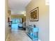 Light and airy foyer with tile flooring, a console table, and views into the living area at 2994 Adrienne Way, The Villages, FL 32163