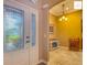 Entryway showcasing a decorative front door, tiled flooring, and an open hallway at 2994 Adrienne Way, The Villages, FL 32163