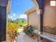 Inviting front porch with a bench, colorful plants, and a view of the home across the street at 2994 Adrienne Way, The Villages, FL 32163