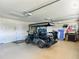 Garage featuring an electric golf cart with room for storage, and epoxy flooring at 2994 Adrienne Way, The Villages, FL 32163