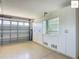 Spacious garage with epoxy flooring and custom storage cabinets along the wall at 2994 Adrienne Way, The Villages, FL 32163