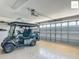 Garage featuring an electric golf cart with room for storage, and epoxy flooring at 2994 Adrienne Way, The Villages, FL 32163