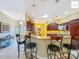Well-equipped kitchen featuring barstool seating, granite countertops, and pendant lighting at 2994 Adrienne Way, The Villages, FL 32163