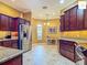This well-designed kitchen features stainless appliances, granite counters and an adjacent dining nook at 2994 Adrienne Way, The Villages, FL 32163