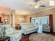 Spacious living room with hardwood floors, comfortable seating, and a view of the dining area at 2994 Adrienne Way, The Villages, FL 32163