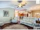 Inviting living room features a ceiling fan, comfortable seating, and seamless flow to the kitchen at 2994 Adrienne Way, The Villages, FL 32163